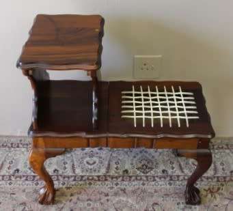 A gorgeous Imbuia ball and claw telephone table with riempies and storage under the seat.
