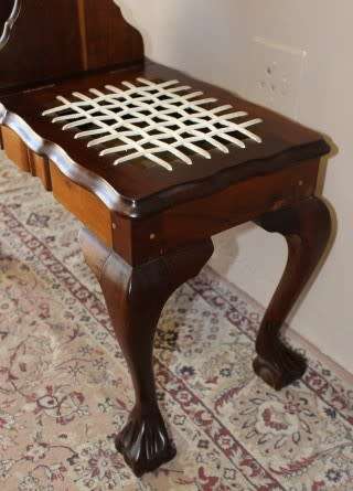 A gorgeous Imbuia ball and claw telephone table with riempies and storage under the seat.