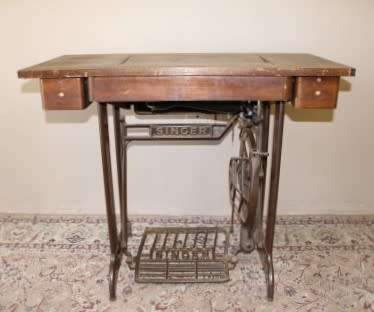 A remarkable antique singer sewing machine oak & cast iron stand with a Harrison sewing machine in.