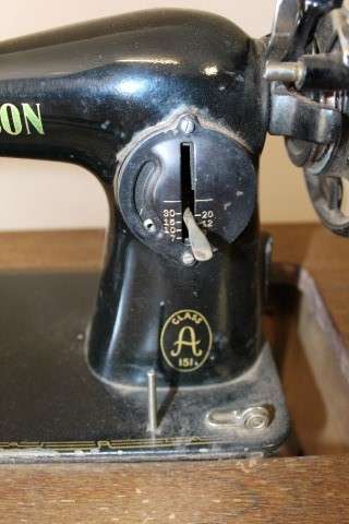 A remarkable antique singer sewing machine oak & cast iron stand with a Harrison sewing machine in.