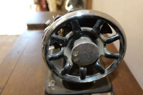 A remarkable antique singer sewing machine oak & cast iron stand with a Harrison sewing machine in.