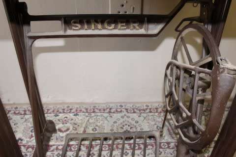 A remarkable antique singer sewing machine oak & cast iron stand with a Harrison sewing machine in.