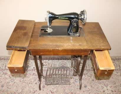 A remarkable antique singer sewing machine oak & cast iron stand with a Harrison sewing machine in.