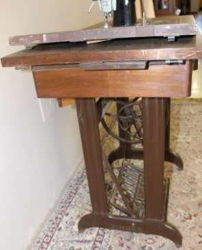 A remarkable antique singer sewing machine oak & cast iron stand with a Harrison sewing machine in.