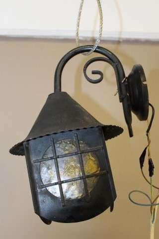 A lovely rustic black metal single wall fitted light, perfect in informal living areas.