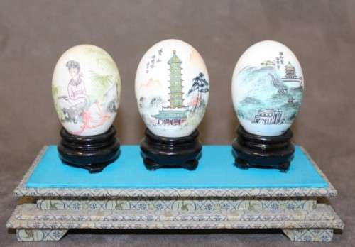 Three stunning hand painted Oriental themed egg ornaments on wooden stands, stunning in a collection