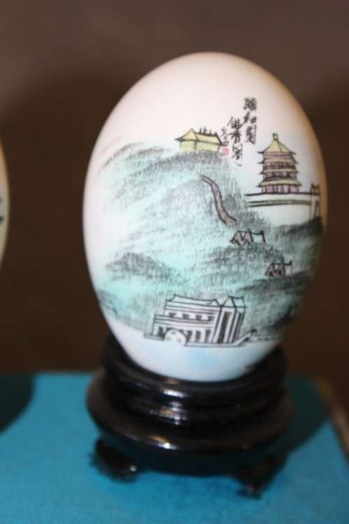 Three stunning hand painted Oriental themed egg ornaments on wooden stands, stunning in a collection