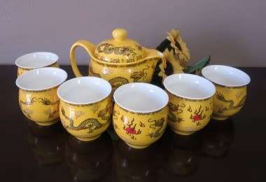 A gorgeous vintage bright yellow oriental dragon themed Chinese tea set .