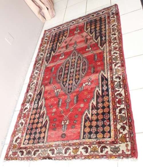 A stunning 125cm x 210cm hand knotted Persian carpet in bright reds. Gorgeous in all rooms!