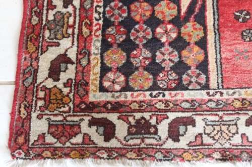 A stunning 125cm x 210cm hand knotted Persian carpet in bright reds. Gorgeous in all rooms!