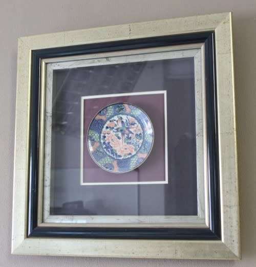 A gorgeous hand painted oriental "Imari" decorative porcelain plate in a box frame behind glass.