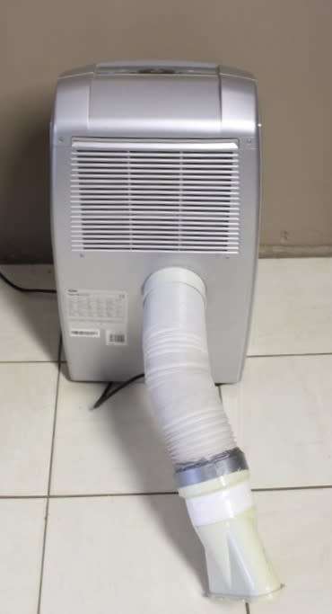 A stylish De Longhi Pinguino PAC C110 portable air conditioner in full working order.