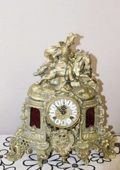 A remarkable vintage French solid brass Horseman mantle clock with Roman numerals