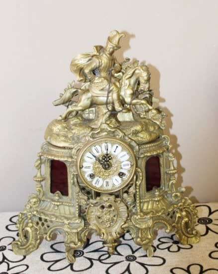 A remarkable vintage French solid brass Horseman mantle clock with Roman numerals