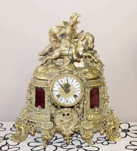 A remarkable vintage French solid brass Horseman mantle clock with Roman numerals