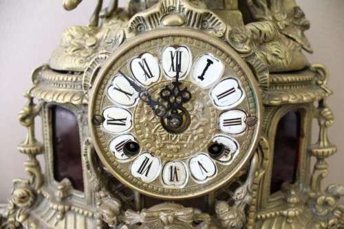 A remarkable vintage French solid brass Horseman mantle clock with Roman numerals