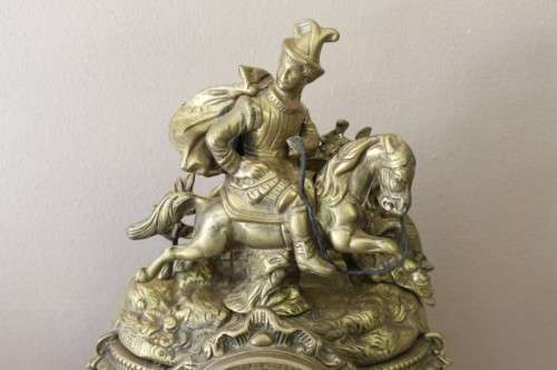A remarkable vintage French solid brass Horseman mantle clock with Roman numerals