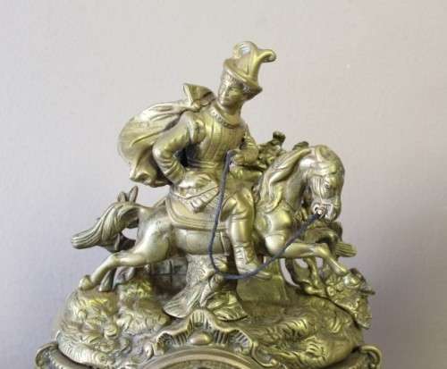 A remarkable vintage French solid brass Horseman mantle clock with Roman numerals