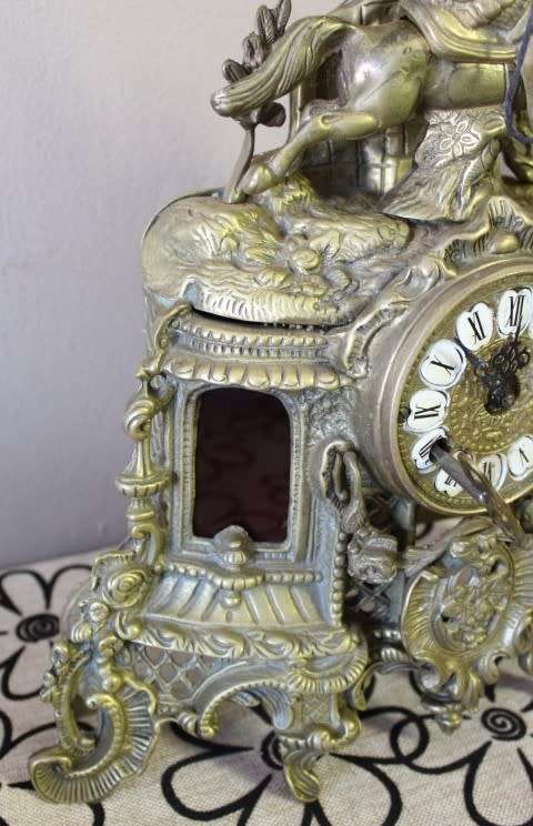 A remarkable vintage French solid brass Horseman mantle clock with Roman numerals