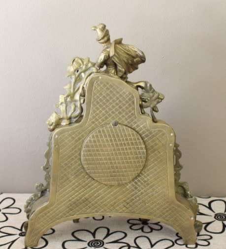 A remarkable vintage French solid brass Horseman mantle clock with Roman numerals
