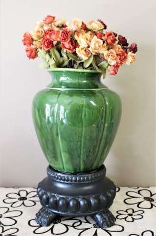 A fabulous large, green ceramic vase with a vase stand, fabulous on display.