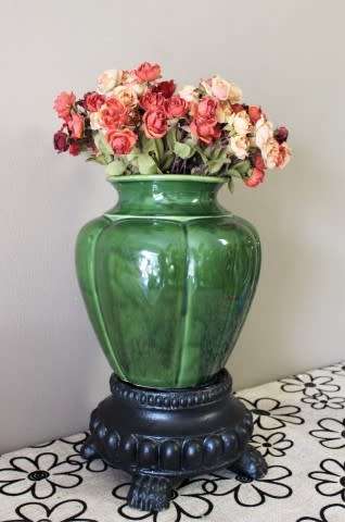 A fabulous large, green ceramic vase with a vase stand, fabulous on display.