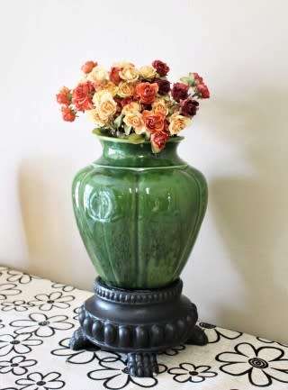 A fabulous large, green ceramic vase with a vase stand, fabulous on display.