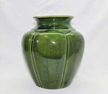 A fabulous large, green ceramic vase with a vase stand, fabulous on display.