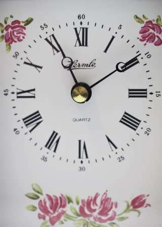 A gorgeous Hermle quartz table clock with a floral design, made in Germany.
