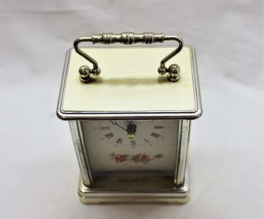 A gorgeous Hermle quartz table clock with a floral design, made in Germany.