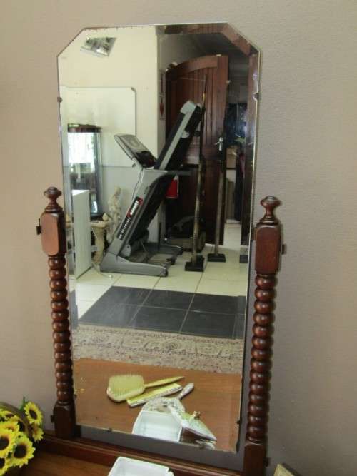 An amazing vintage Oak dressing table with a tilting bevelled centre mirror and three drawers.