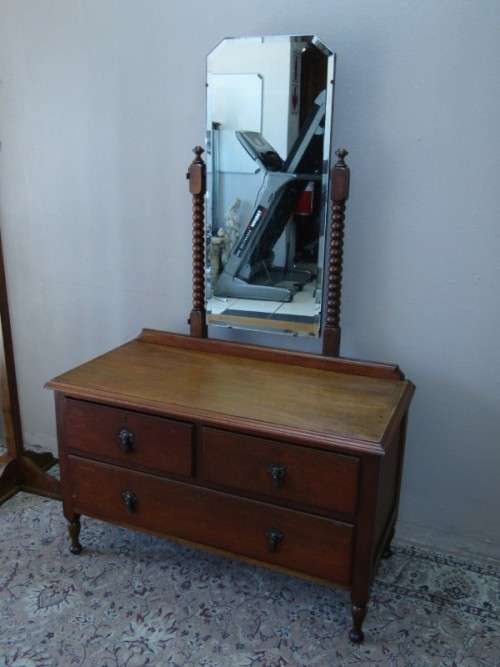 An amazing vintage Oak dressing table with a tilting bevelled centre mirror and three drawers.