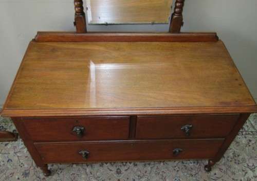 An amazing vintage Oak dressing table with a tilting bevelled centre mirror and three drawers.