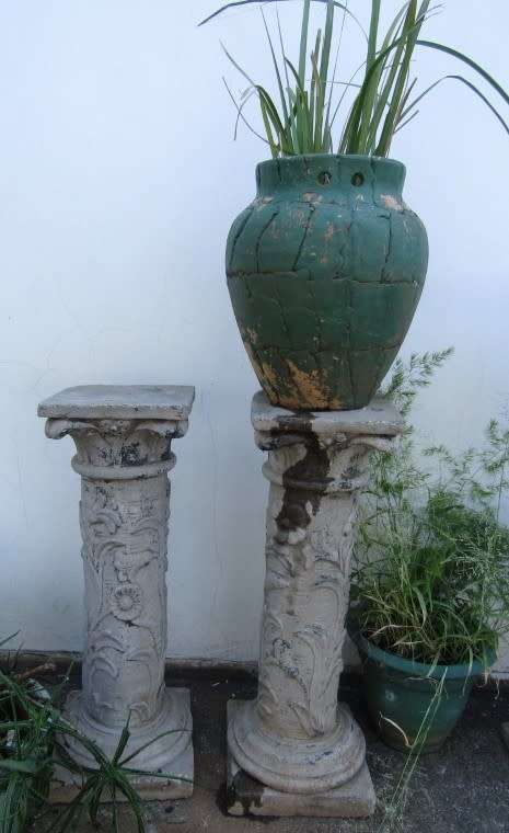 Two lovely concrete pillars. Perfect in a garden or drive way with a statue or plant!!