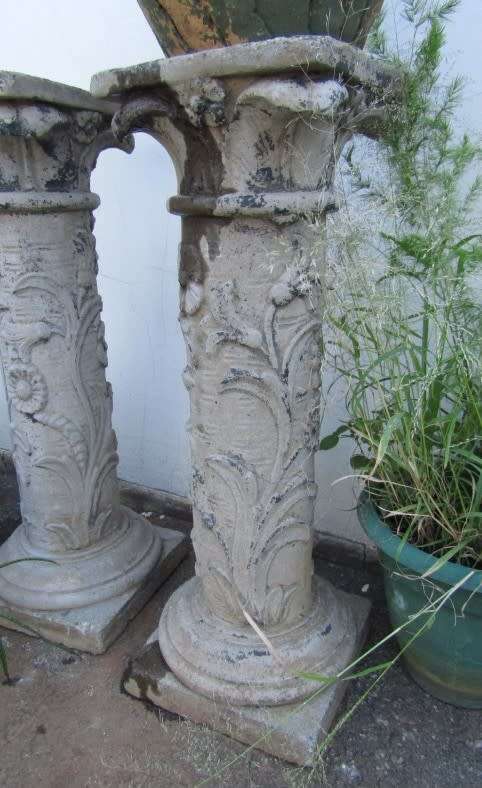 Two lovely concrete pillars. Perfect in a garden or drive way with a statue or plant!!