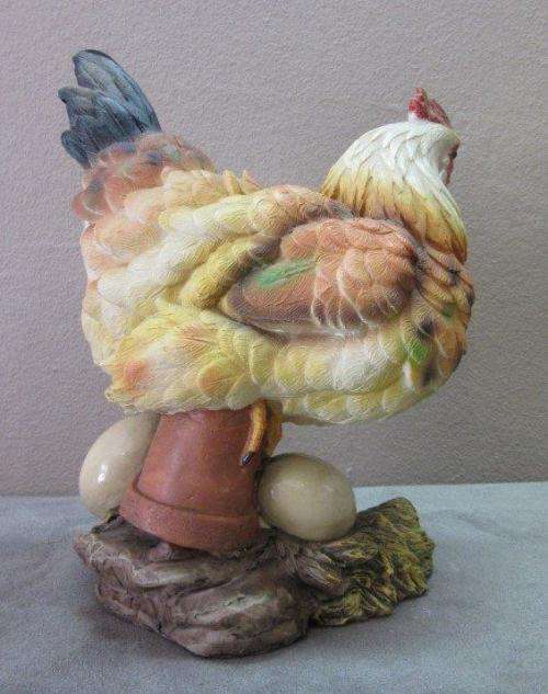 A wonderful little plastic figurine of a hen surrounded by eggs, fabulous on display.