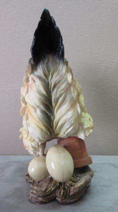 A wonderful little plastic figurine of a hen surrounded by eggs, fabulous on display.