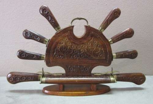 An awesome collectible hand carved Indian knife and fork carving set in a wood stand w/ brass trim