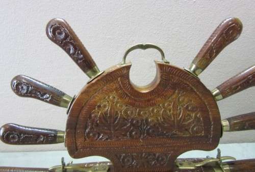 An awesome collectible hand carved Indian knife and fork carving set in a wood stand w/ brass trim
