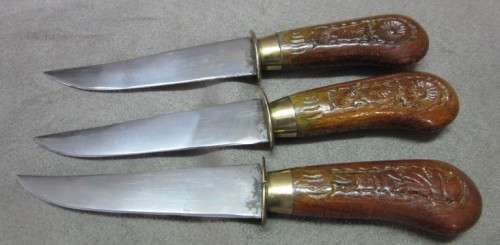 An awesome collectible hand carved Indian knife and fork carving set in a wood stand w/ brass trim