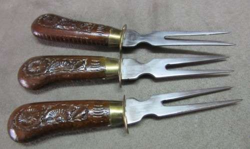 An awesome collectible hand carved Indian knife and fork carving set in a wood stand w/ brass trim