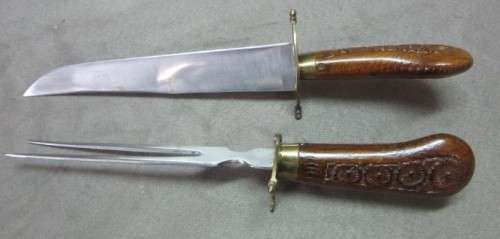 An awesome collectible hand carved Indian knife and fork carving set in a wood stand w/ brass trim