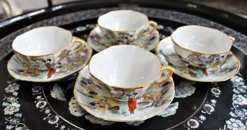 A stunning oriental porcelain tea set of four trio's including a tea pot, milk jug & sugar pot!