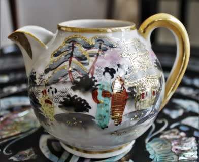 A stunning oriental porcelain tea set of four trio's including a tea pot, milk jug & sugar pot!