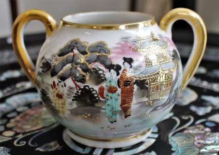 A stunning oriental porcelain tea set of four trio's including a tea pot, milk jug & sugar pot!