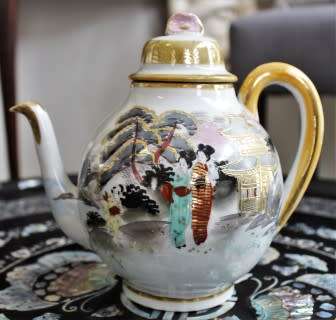 A stunning oriental porcelain tea set of four trio's including a tea pot, milk jug & sugar pot!