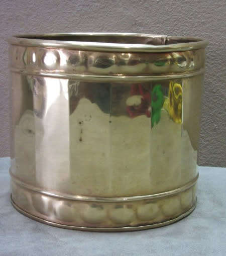 A solid brass pot planter with punched detailing. Gorgeous in all living areas! Lifespace Sale
