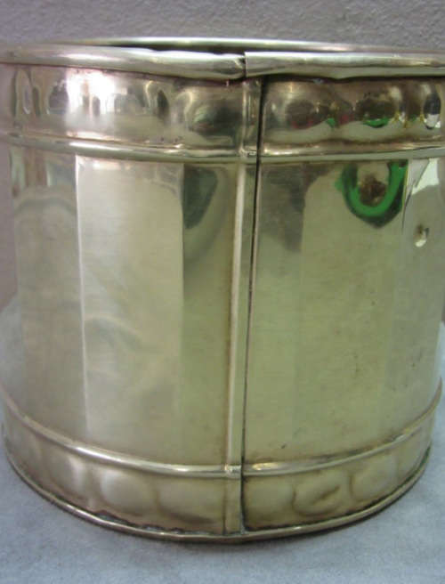 A solid brass pot planter with punched detailing. Gorgeous in all living areas! Lifespace Sale