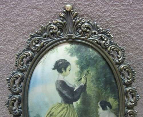 A lovely oval framed silk tapestry of a woman and a dog, made in Italy. Gorgeous!
