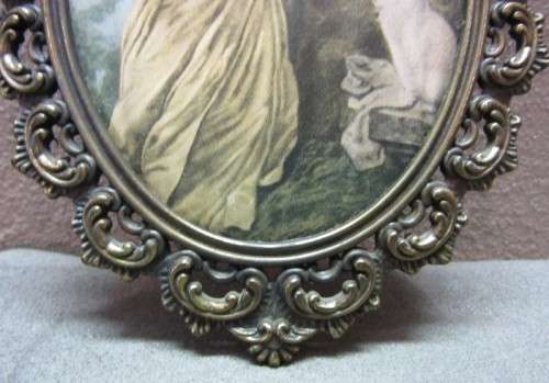 A lovely oval framed silk tapestry of a woman and a dog, made in Italy. Gorgeous!